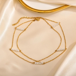 Double-layered golden stainless steel choker with faceted white crystal beads and extension chain