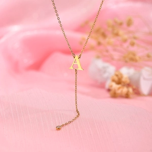 Gold stainless steel necklace with letter A pendant and white zircon tassel detail