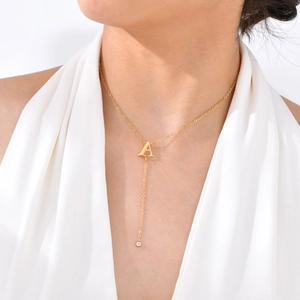 Golden Y-shaped necklace with letter A pendant and sparkling cubic zirconia tassel