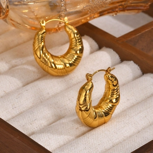 Polished gold stainless steel C-shaped earrings with textured diagonal ribbing detail
