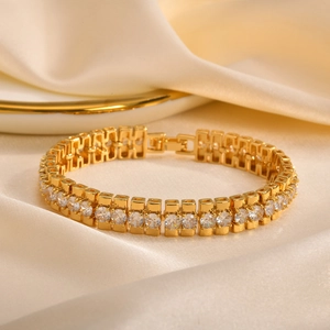 Detailed close-up of golden link bracelet with inlaid round-cut cubic zirconia crystals