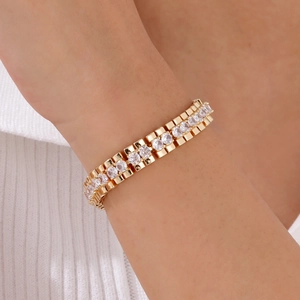 Close-up of gold-plated link bracelet with inlaid round cubic zirconia on a wrist