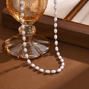 Elegant gold-plated necklace featuring polished rice-shaped pearls and a fine link chain