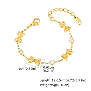 Close-up of gold butterfly bracelet showing K18 hallmark and zircon stone details