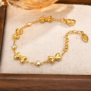 Detailed close-up of 18K gold-plated butterfly bracelet with zircons and K18 engraving