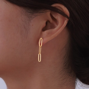 Elegant gold-plated stainless steel long oval chain drop earrings worn by a model