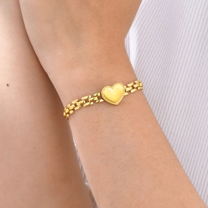 Polished gold heart charm bracelet with rectangular link chain for women on wrist