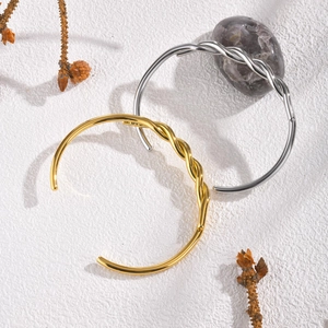 Twisted stainless steel open cuff bracelet in gold and silver finish for women