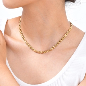 Golden stainless steel watchband link chain necklace displayed on a female model
