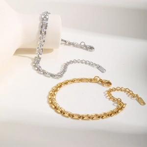 Detail of gold and silver watchband chain bracelets with lobster clasp and K18 tag