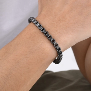 Close-up of men's black stainless steel Venetian box chain bracelet on a male wrist