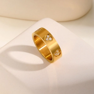Golden stainless steel ring with hollow hearts and sparkling zircons on stone base