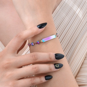 Rainbow plated stainless steel bracelet with heart links shown on a model wrist