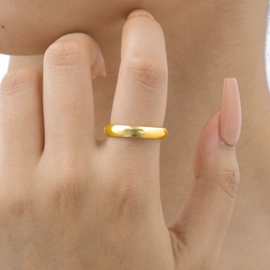 Polished 14K gold stainless steel wide band ring worn on finger with mirror finish