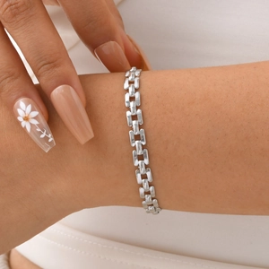 Polished silver stainless steel link bracelet with flat rectangular loops on woman's wrist