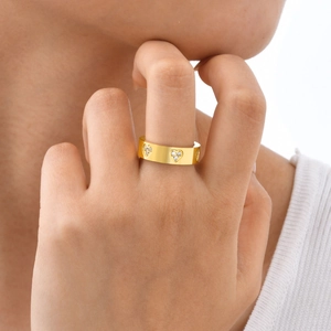 Gold stainless steel heart ring with cubic zirconia stones worn on finger