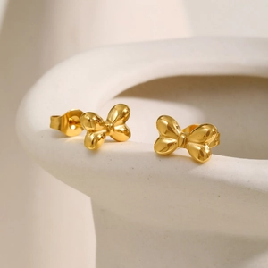 Boucles d'oreilles nœud 3D dorées en acier inoxydable poli sur support en céramique