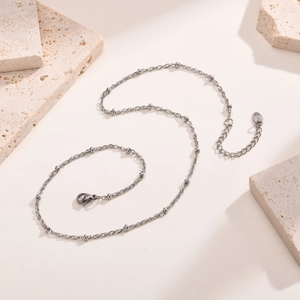 Close-up of silver stainless steel bead chain necklace with adjustable lobster clasp