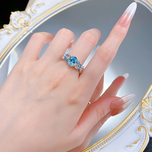 Macro view of blue cocktail ring with hydrangea petals and crystal floral accents
