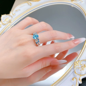 Detailed close-up of S925 silver ring with 2ct sky blue zircon in floral design