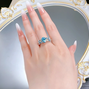 Detailed view of an S925 silver ring featuring a large oval blue gemstone worn on a hand