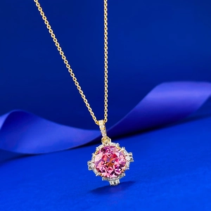 Elegant 11mm lotus cut pink corundum pendant with diamond accents on a gold O-chain