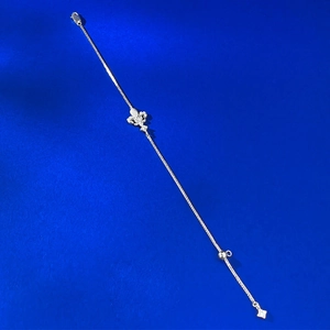 Detail of S925 silver iris flower bracelet with pavé diamonds on deep blue background