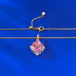 S925 silver gold-plated necklace with pink gemstone lotus-cut pendant on blue background