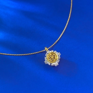 Close-up of S925 hallmark on a luxury gold-plated sunflower pendant with zircons