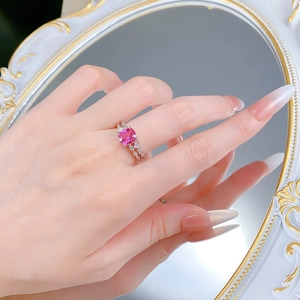 Detail of a pink square gemstone ring on silver band with sparkling zircon accents