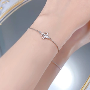 Detail of S925 silver iris flower bracelet with white zircons on a model's wrist