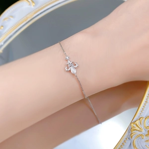 Detail of S925 sterling silver fleur-de-lis bracelet with micro-pave zircons on a wrist