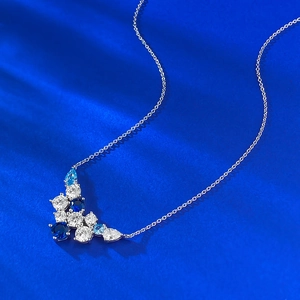 Elegant S925 silver necklace with blue crystal cluster pendant on luxury blue silk background