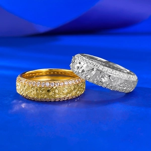 Close-up of gold and silver S925 rings with hammered texture and pavé diamond edges