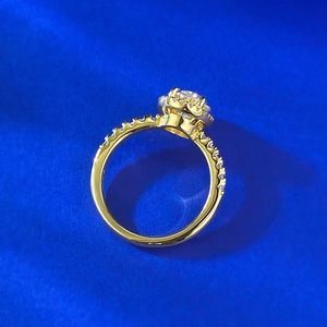 Close-up of golden S925 silver ring with oval halo diamond and pavé side stones