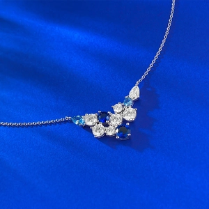 Elegant S925 silver necklace with blue and white cluster crystals on blue velvet background