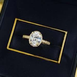 Elegant S925 silver oval-cut diamond ring with golden halo setting in velvet box