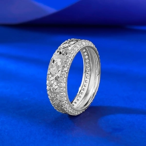 Macro detail of silver wide ring with crushed ice texture and side pave-set zircon stones