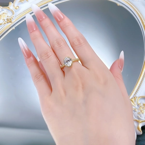 Close-up of S925 silver halo ring with oval cut white gemstone on hand with manicure
