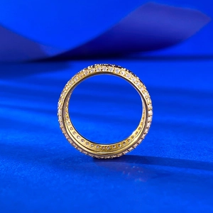 Macro view of gold eternity ring with crushed ice pavé setting and micro-inlaid stones