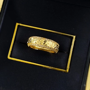 Macro detail of gold hammered ring with dual-row pave-set white cubic zirconia stones