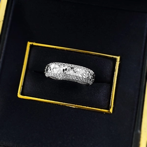 Macro shot of silver wide band ring with hammered texture and double row zircon stones