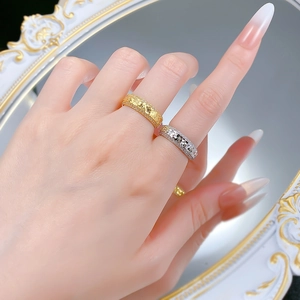 Detailed view of luxury S925 silver rings with pavé setting and embossed metal texture
