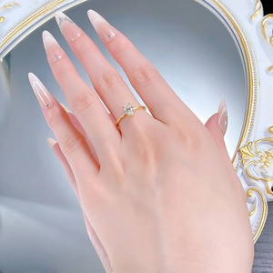 Close-up of 1 carat oval cut solitaire ring in gold finish on model finger