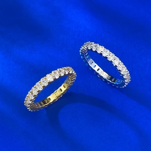 Detail of S925 sterling silver eternity rings in gold and silver with full diamond setting