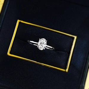 Macro detail of oval cut solitaire ring with S925 engraving in blue jewelry box