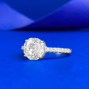Macro side view of an 8-sided cut moissanite engagement ring with micro-pave diamonds
