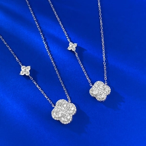 S925 silver necklace featuring a sparkling pavé four-leaf clover pendant on blue backdrop