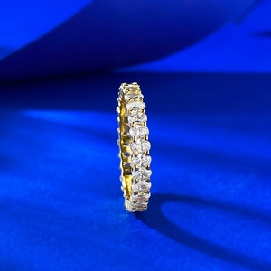 Macro shot of gold eternity ring with oval cut diamonds in a refined claw setting