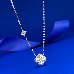 Macro shot of silver four-leaf clover pendant necklace with sparkling micro-pave crystals